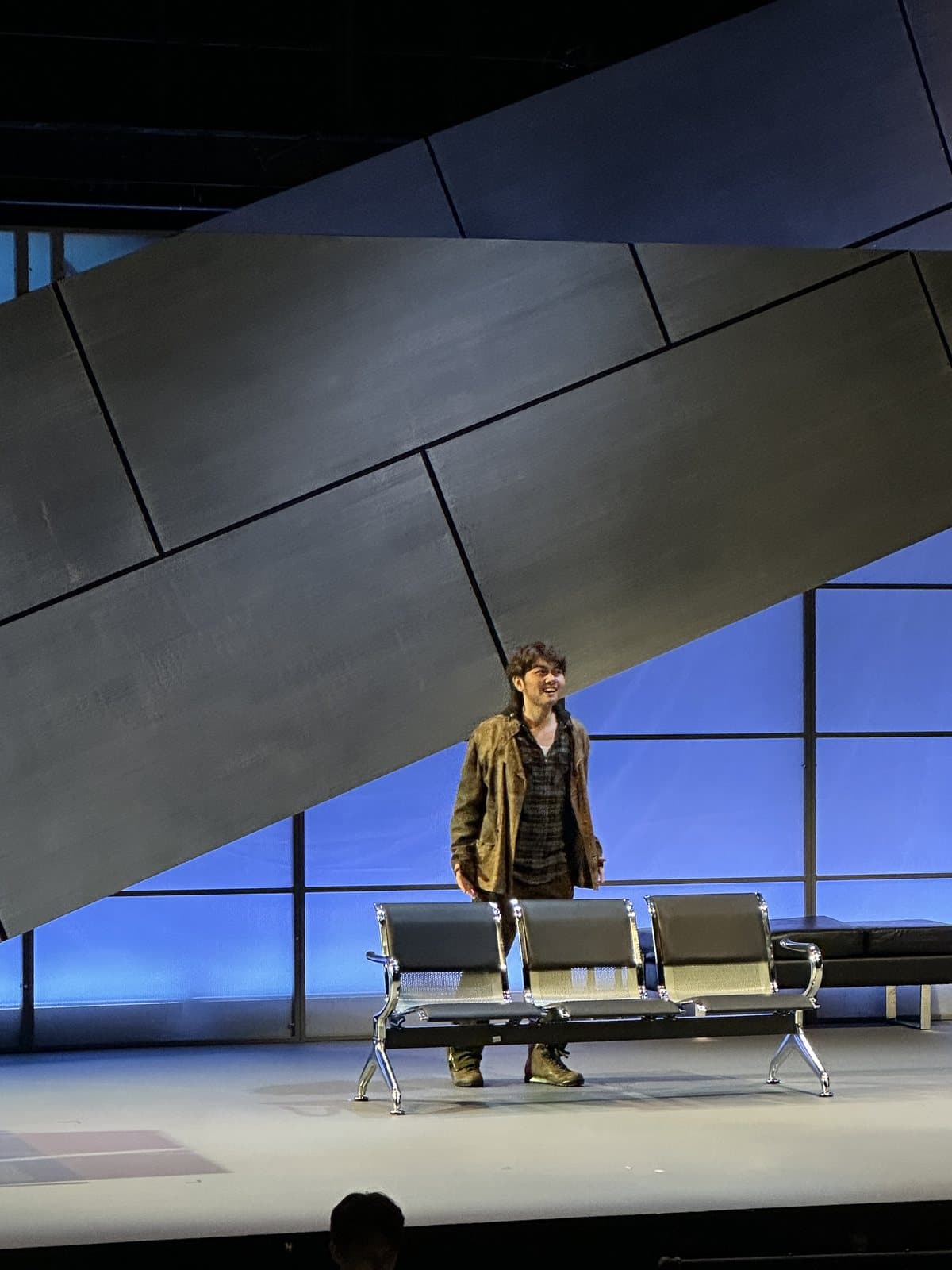 The Refugee alone under a spotlight in Flight